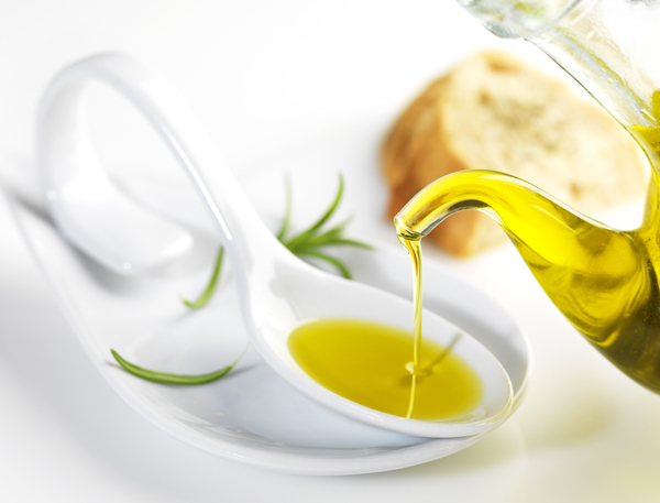virgin olive oil pouring in a spoon